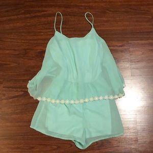 Turquoise romper with flower details